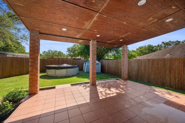 view of patio / terrace featuring a storage shed, an outdoor structure, and a fenced backyard