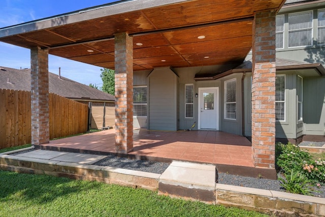 property entrance with a patio area and fence