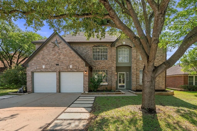 traditional home with a garage, brick siding, a front lawn, and concrete driveway