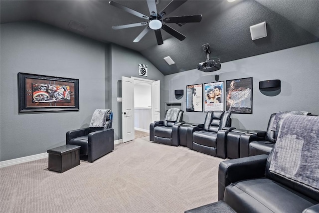 cinema room with a ceiling fan, carpet flooring, vaulted ceiling, and baseboards
