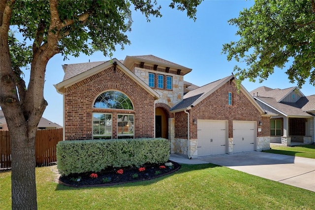 traditional-style home featuring a garage, fence, a front lawn, and stone siding