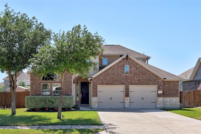 traditional-style house with a front yard, stone siding, concrete driveway, an attached garage, and fence