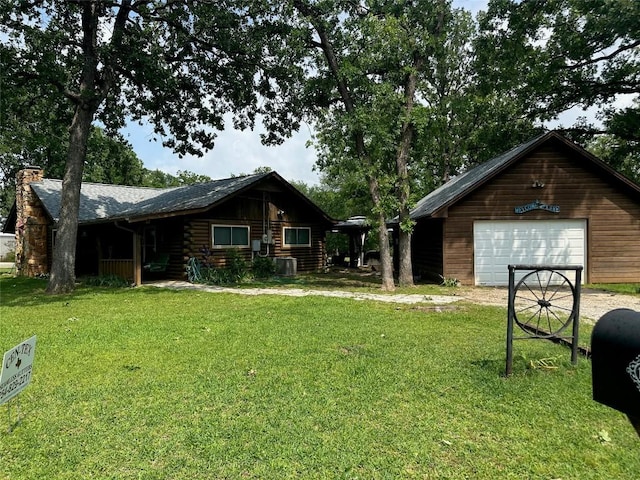 log home with a chimney, a garage, driveway, a front lawn, and log siding