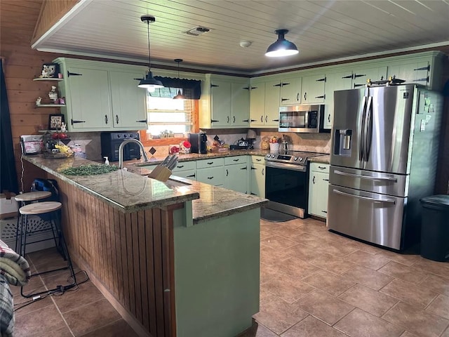 kitchen featuring green cabinetry, stainless steel appliances, a sink, visible vents, and a peninsula