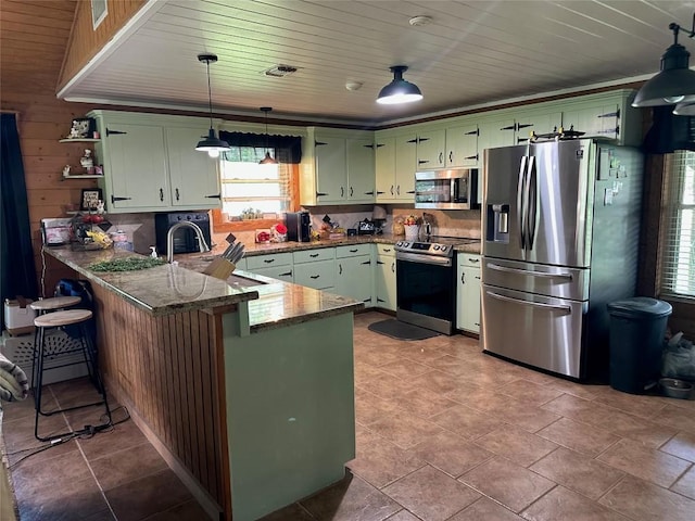 kitchen with stainless steel appliances, open shelves, green cabinets, a sink, and a peninsula