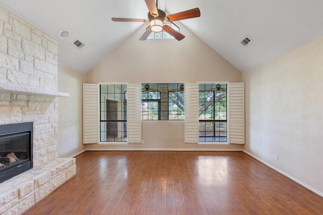 unfurnished living room featuring high vaulted ceiling, visible vents, hardwood / wood-style flooring, and a fireplace