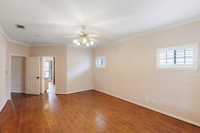 spare room featuring visible vents, a ceiling fan, baseboards, and hardwood / wood-style flooring