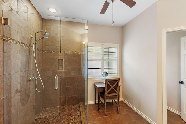 bathroom with a ceiling fan, baseboards, a shower stall, and tile patterned flooring