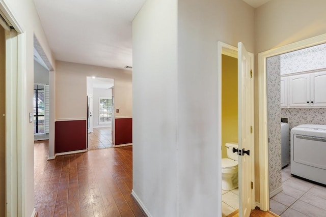 corridor with baseboards and wood-type flooring