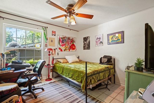 tiled bedroom featuring baseboards and ceiling fan