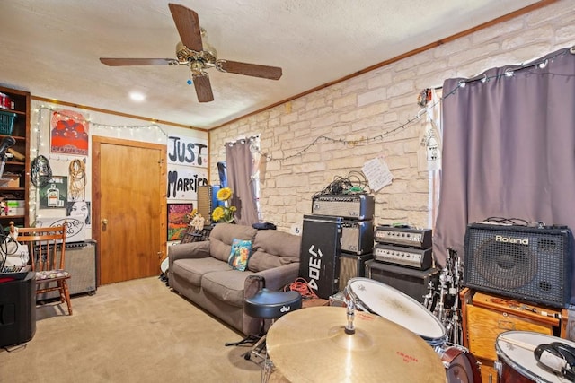 carpeted living area featuring a textured ceiling, ceiling fan, and crown molding