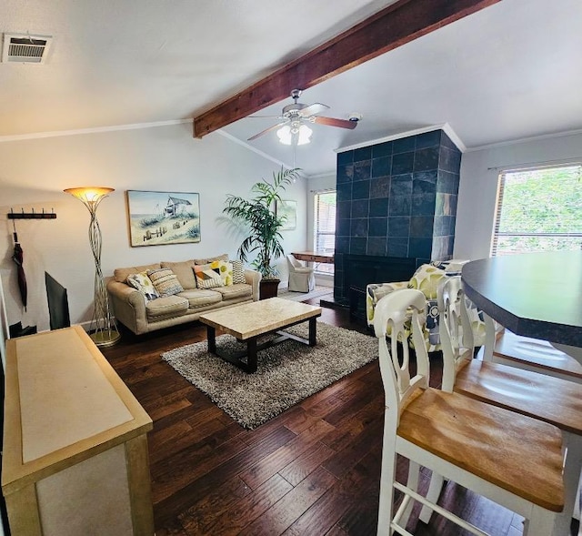 living room with vaulted ceiling with beams, hardwood / wood-style flooring, ceiling fan, a fireplace, and visible vents