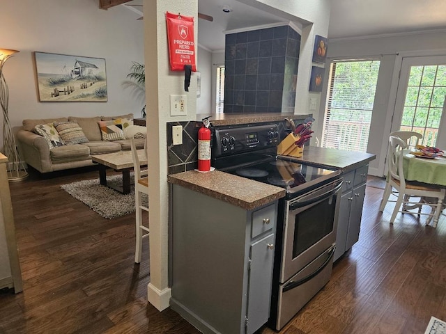 kitchen featuring dark wood-style flooring, open floor plan, stainless steel range with electric cooktop, and crown molding