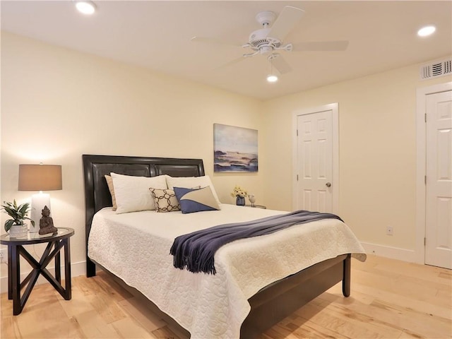 bedroom featuring recessed lighting, visible vents, light wood-style flooring, and baseboards