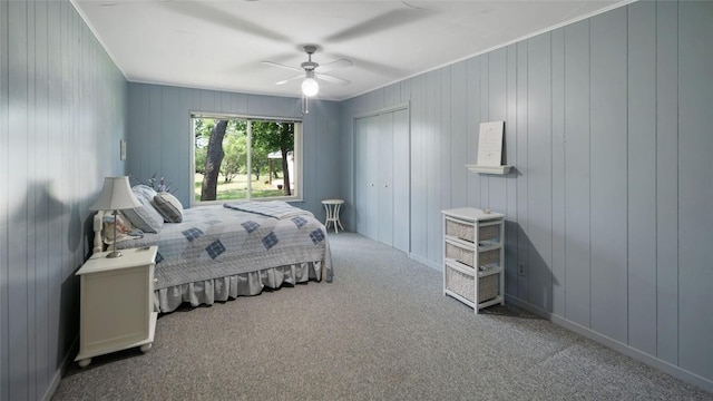 carpeted bedroom with a ceiling fan and a closet