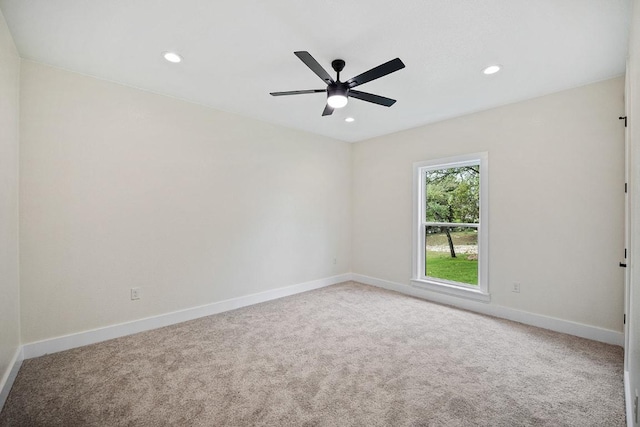 carpeted empty room with recessed lighting, a ceiling fan, and baseboards