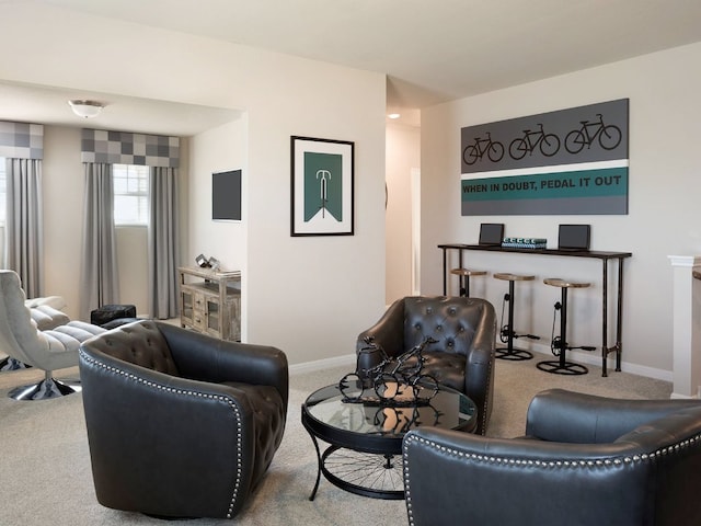 carpeted living room with baseboards