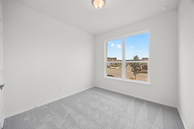 121 Coastal Way, Georgetown, TX 78628 - carpeted empty room with baseboards and a smoke detector
