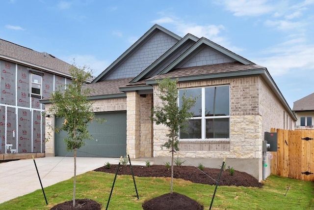 121 Coastal Way, Georgetown, TX 78628 - view of front of property featuring driveway, a garage, roof with shingles, and stone siding