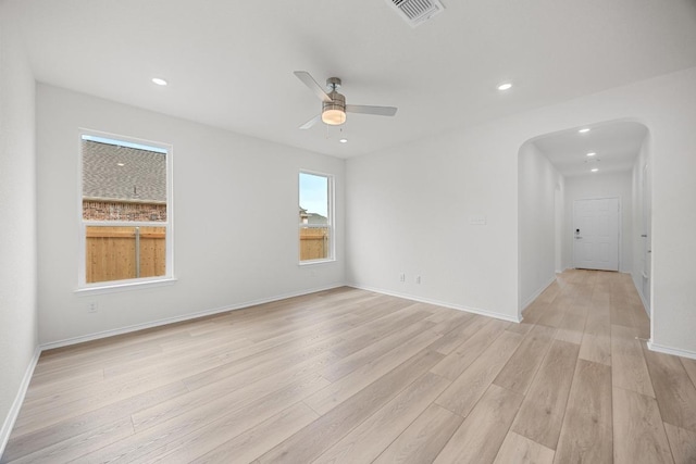 121 Coastal Way, Georgetown, TX 78628 - empty room with arched walkways, light wood-style floors, a ceiling fan, recessed lighting, and baseboards