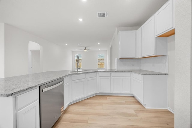121 Coastal Way, Georgetown, TX 78628 - kitchen with stainless steel dishwasher, a sink, light wood-style floors, light stone countertops, and recessed lighting