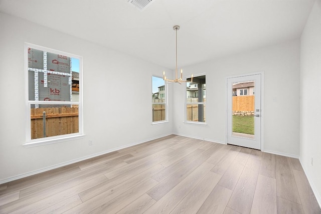 121 Coastal Way, Georgetown, TX 78628 - empty room with a chandelier, wood finished floors, and baseboards