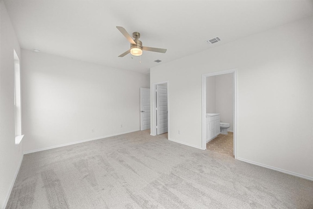 121 Coastal Way, Georgetown, TX 78628 - unfurnished bedroom with carpet, baseboards, ensuite bath, and a ceiling fan