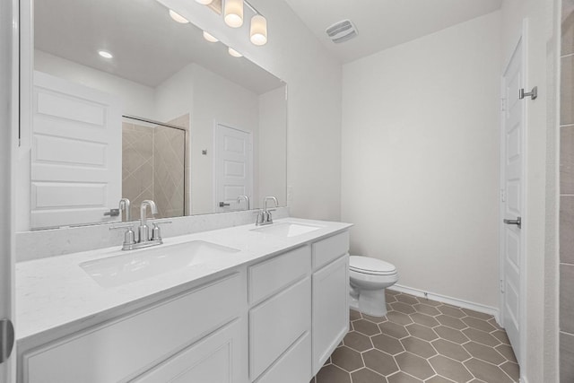 121 Coastal Way, Georgetown, TX 78628 - bathroom featuring double vanity, tiled shower, toilet, tile patterned floors, and recessed lighting