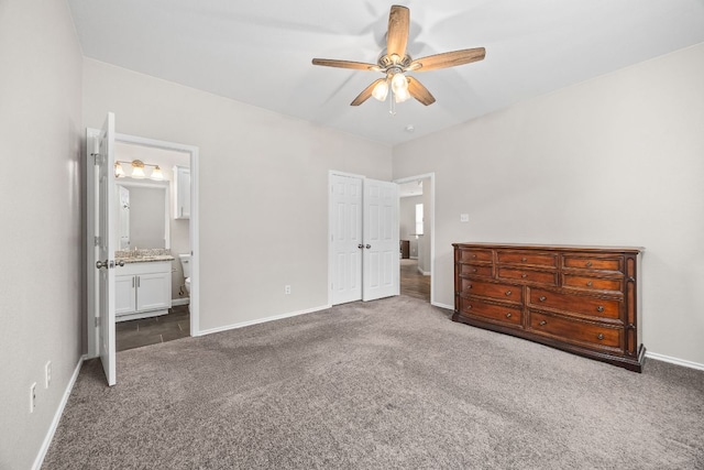 unfurnished bedroom featuring baseboards, a ceiling fan, carpet floors, and connected bathroom