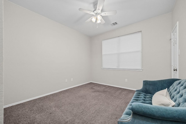 sitting room featuring baseboards, visible vents, a ceiling fan, and carpet floors