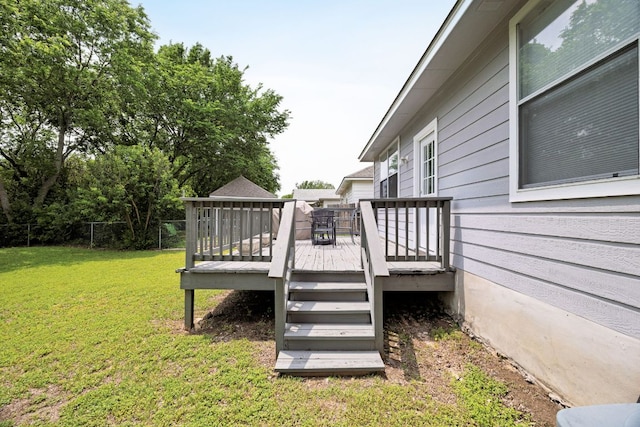 deck with a lawn and fence