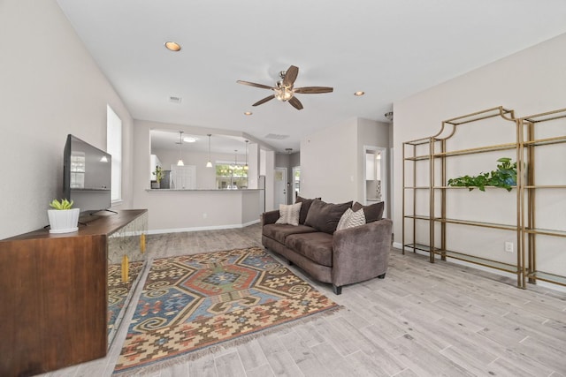 living room featuring baseboards, recessed lighting, wood finished floors, and ceiling fan