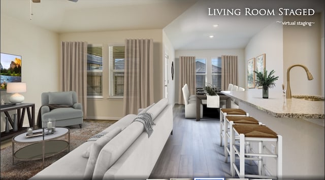 living area with baseboards, recessed lighting, wood finished floors, and ceiling fan