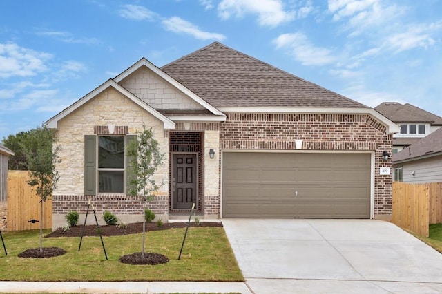 109 Coastal Way, Georgetown, TX 78628 - view of front facade featuring concrete driveway, brick siding, an attached garage, and a shingled roof