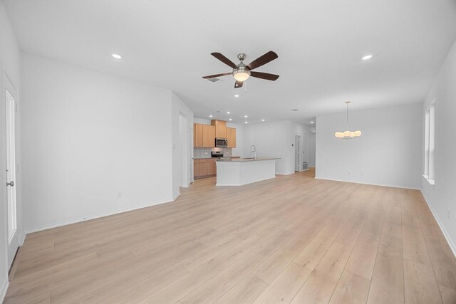 109 Coastal Way, Georgetown, TX 78628 - unfurnished living room featuring ceiling fan, a chandelier, recessed lighting, light wood-style flooring, and baseboards