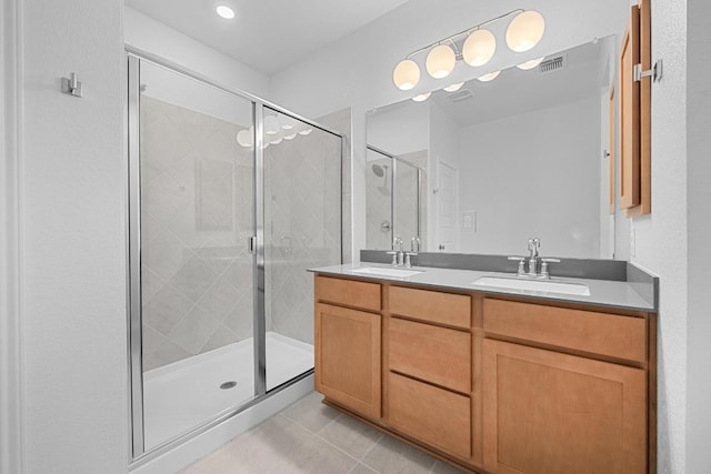 109 Coastal Way, Georgetown, TX 78628 - bathroom featuring double vanity, tile patterned flooring, and a shower stall