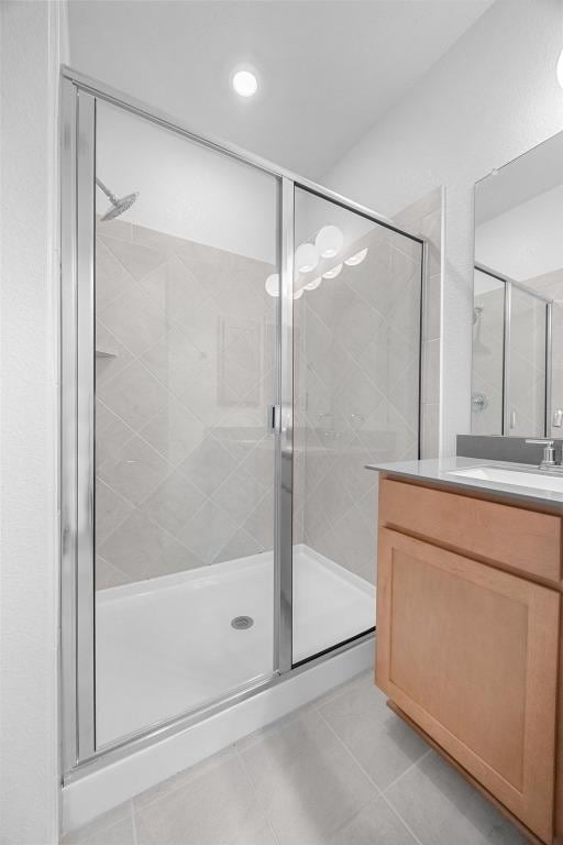 109 Coastal Way, Georgetown, TX 78628 - bathroom featuring tile patterned flooring, vanity, and a stall shower