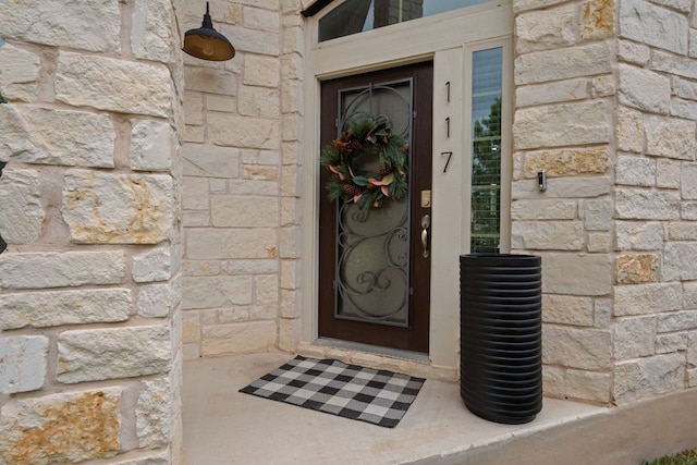 view of exterior entry featuring stone siding