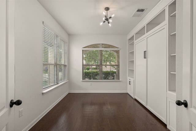 117 Rock Mill Loop, Georgetown, TX 78626 - unfurnished bedroom featuring a chandelier, dark wood-style flooring, and baseboards