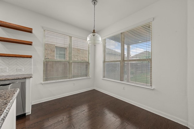 117 Rock Mill Loop, Georgetown, TX 78626 - unfurnished dining area with baseboards and dark wood-style flooring