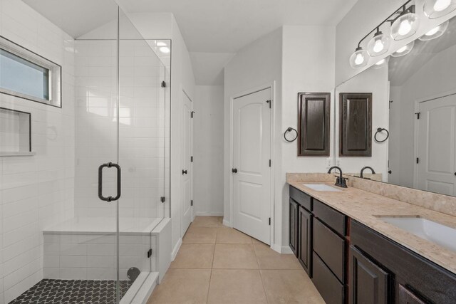 bathroom featuring a sink, tile patterned floors, and a shower stall