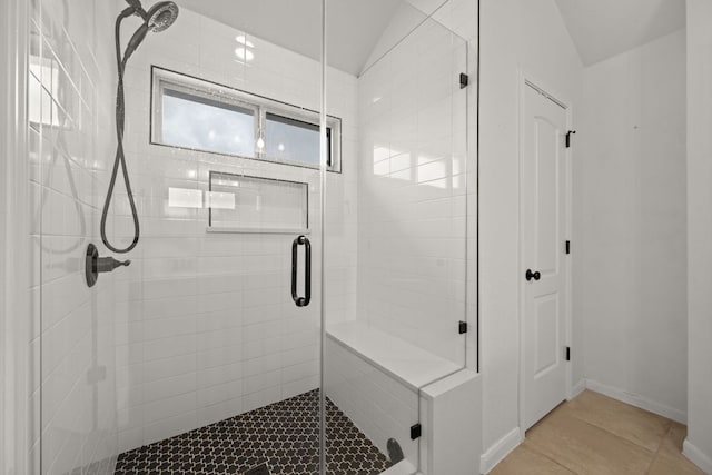full bath with baseboards, tile patterned flooring, and a stall shower
