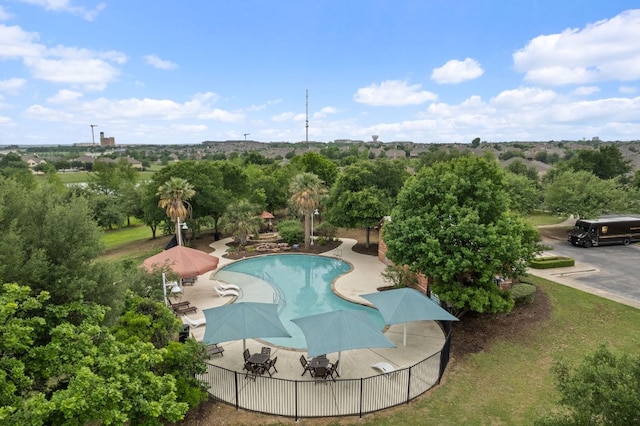 view of swimming pool with a patio, fence, and a fenced in pool
