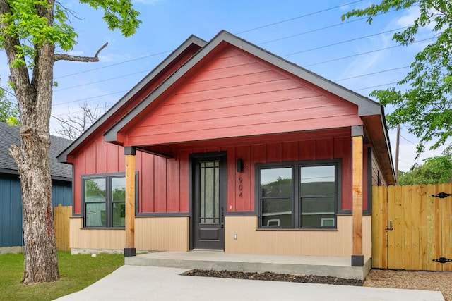 bungalow-style house featuring fence and a gate