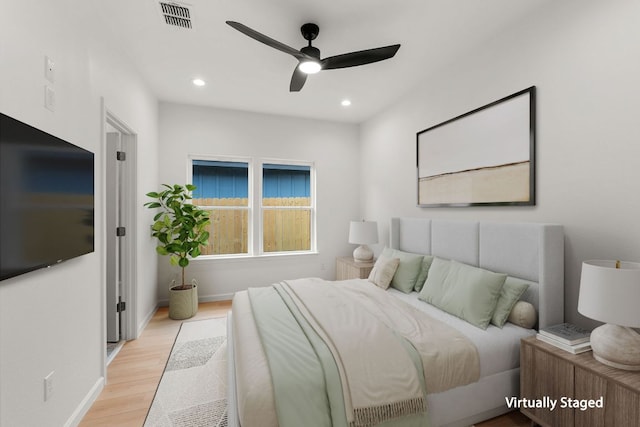 bedroom featuring baseboards, visible vents, wood finished floors, and recessed lighting