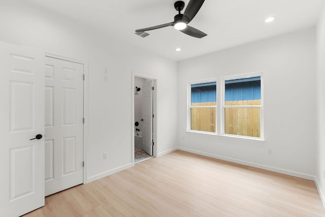 unfurnished bedroom featuring recessed lighting, light wood-style flooring, and baseboards