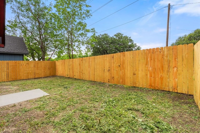 view of yard with a fenced backyard