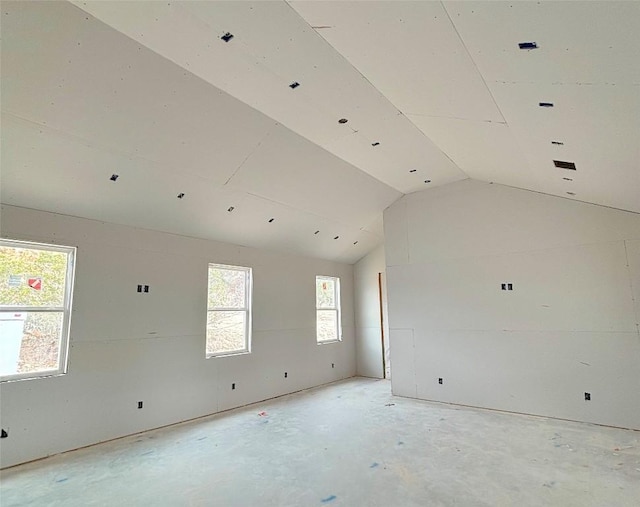empty room featuring lofted ceiling