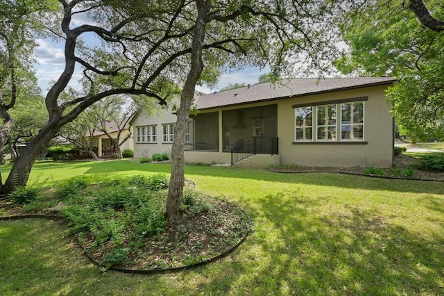 112 Hill Country Dr, Georgetown, TX 78633 - back of property featuring stucco siding, a lawn, and a sunroom