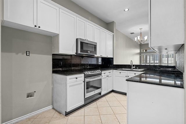 kitchen with a sink, an inviting chandelier, tasteful backsplash, white cabinetry, and appliances with stainless steel finishes